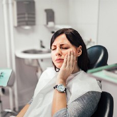 Woman with tooth pain at dental office