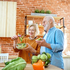 Older couple preparing a meal together