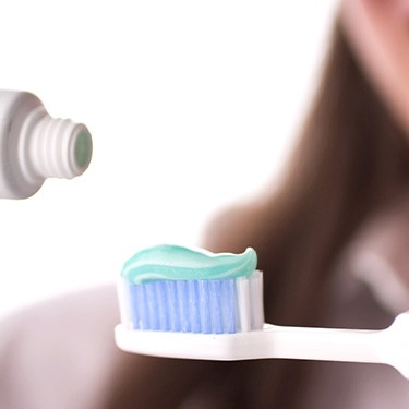 Toothpaste is applied to brush