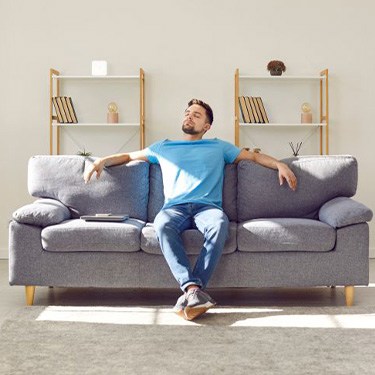 Man resting on his sofa at home