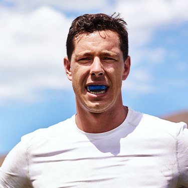 Man wears athletic mouthguard