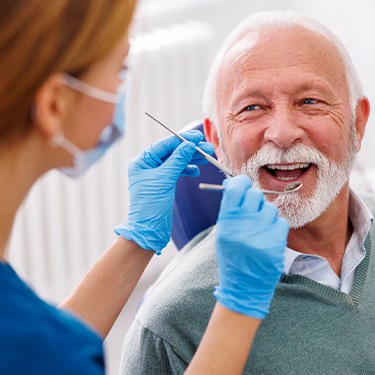 Man smiles at dental hygienist