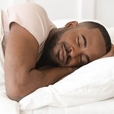 Man sleeping peacefully in comfortable bed