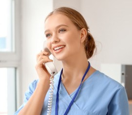 dental team member smiling on the phone