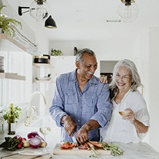 Older couple prepping vegetables for a meal