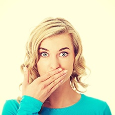 A young woman covering her mouth.